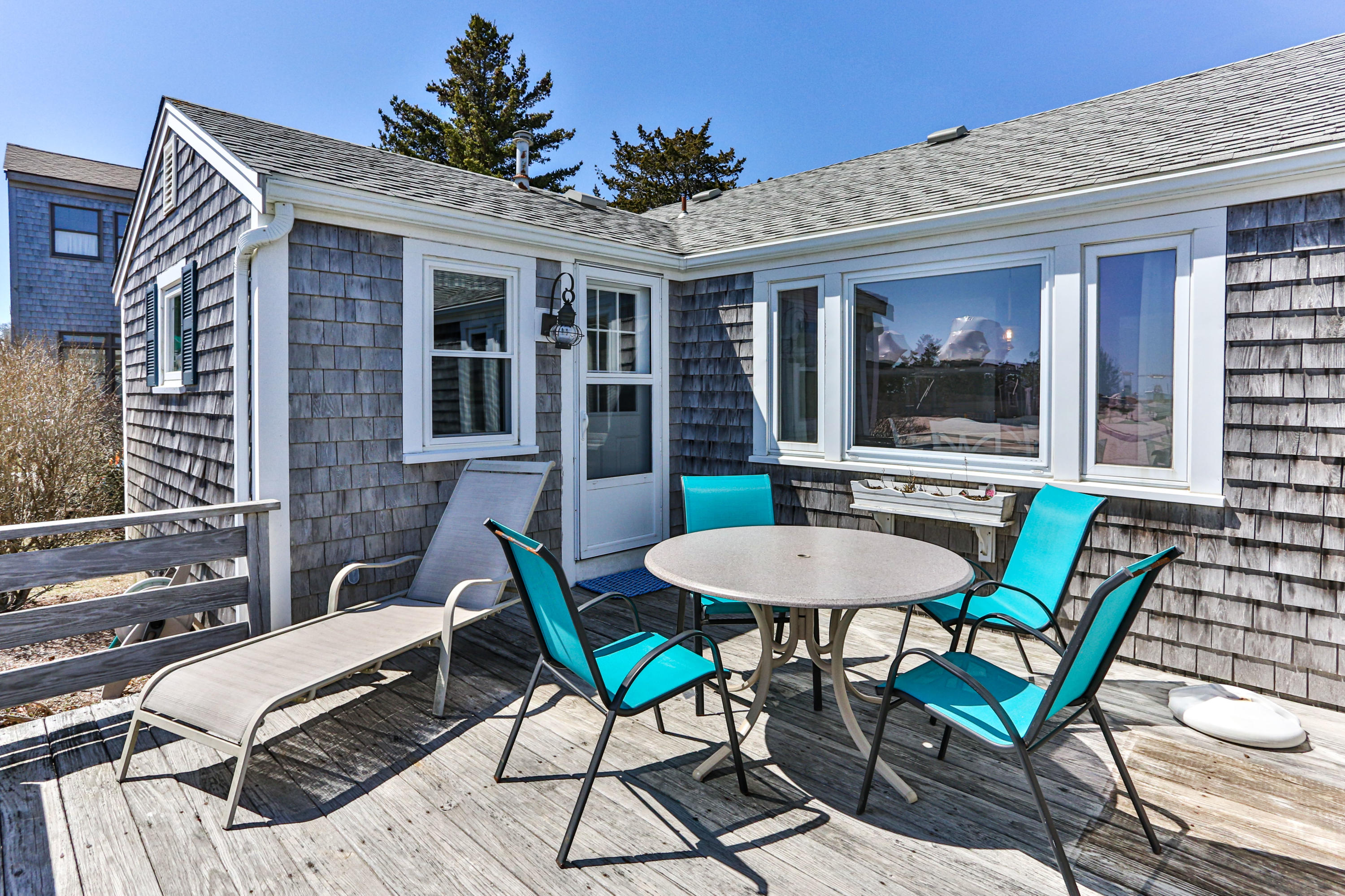 115 Seagull Road Chatham, MA 02633 - Photo 21 of 29 a view of a house with a backyard and a chair