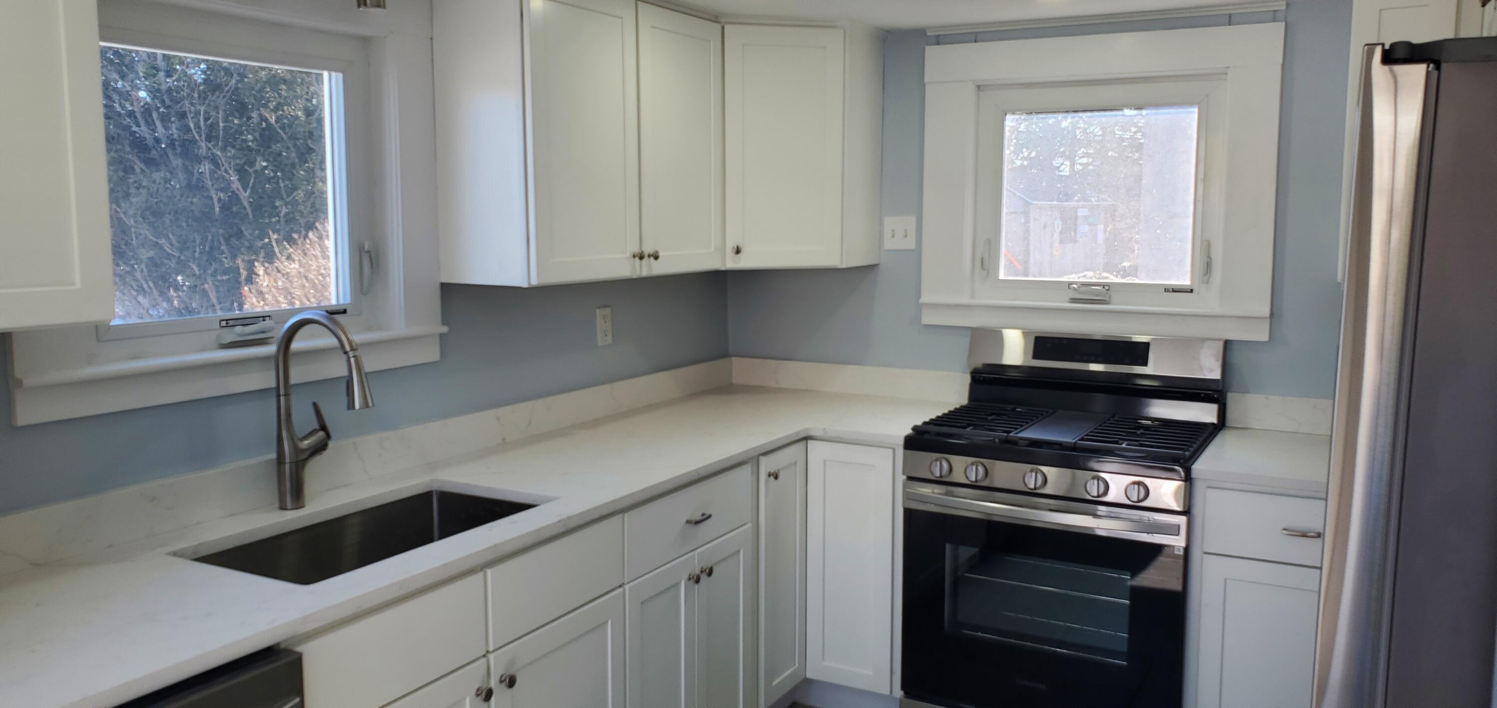 115 Seagull Road Chatham, MA 02633 - Photo 25 of 29 a kitchen with granite countertop a stove a sink and a microwave