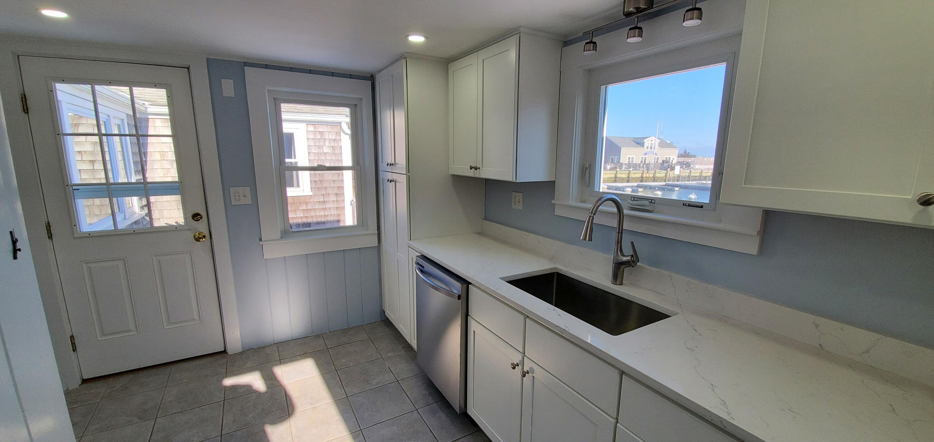 115 Seagull Road Chatham, MA 02633 - Photo 26 of 29 a kitchen with stainless steel appliances a sink stove and cabinets