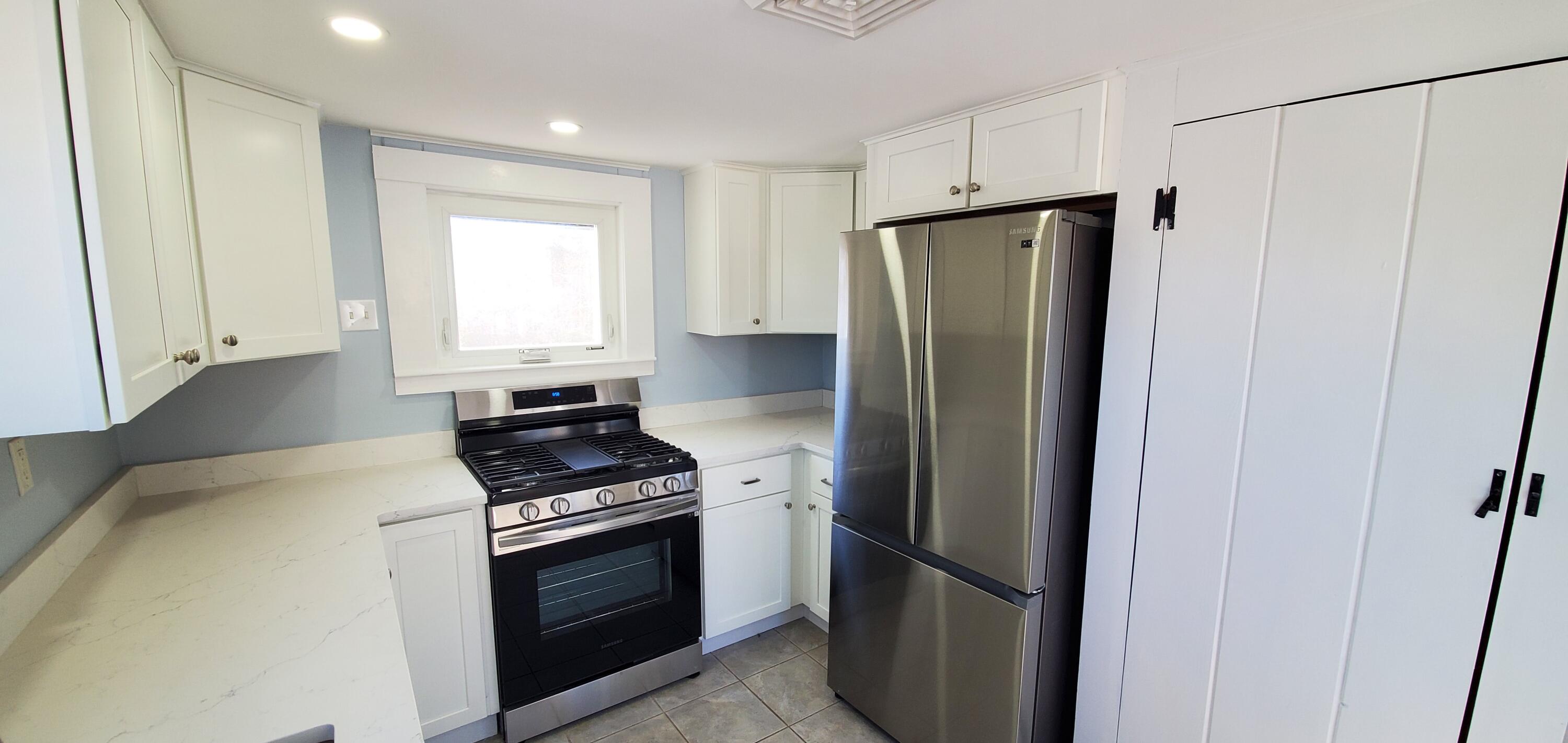115 Seagull Road Chatham, MA 02633 - Photo 27 of 29 a kitchen with a refrigerator and a window
