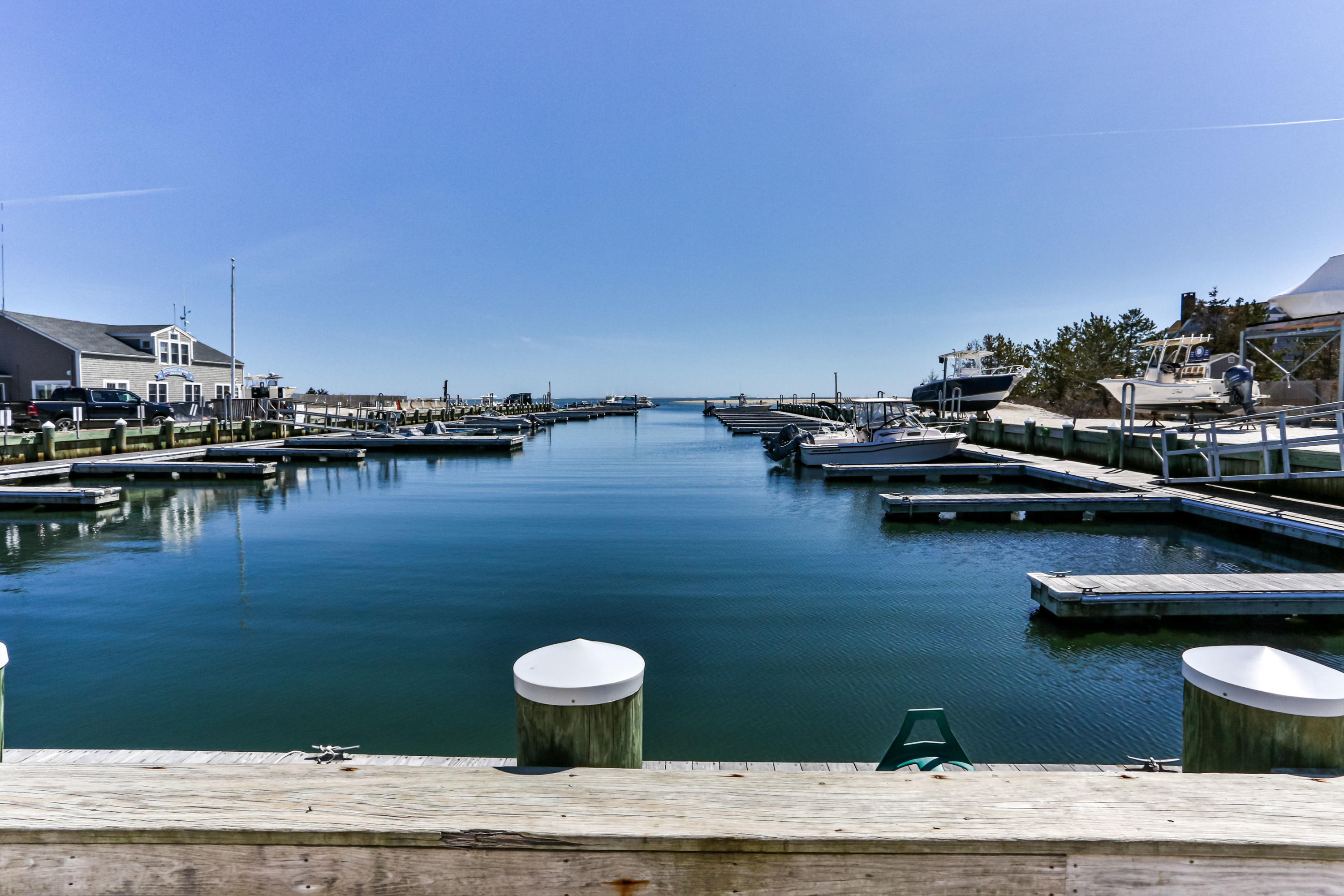 115 Seagull Road Chatham, MA 02633 - Photo 4 of 29 a view of a lake with boats and trees in the background