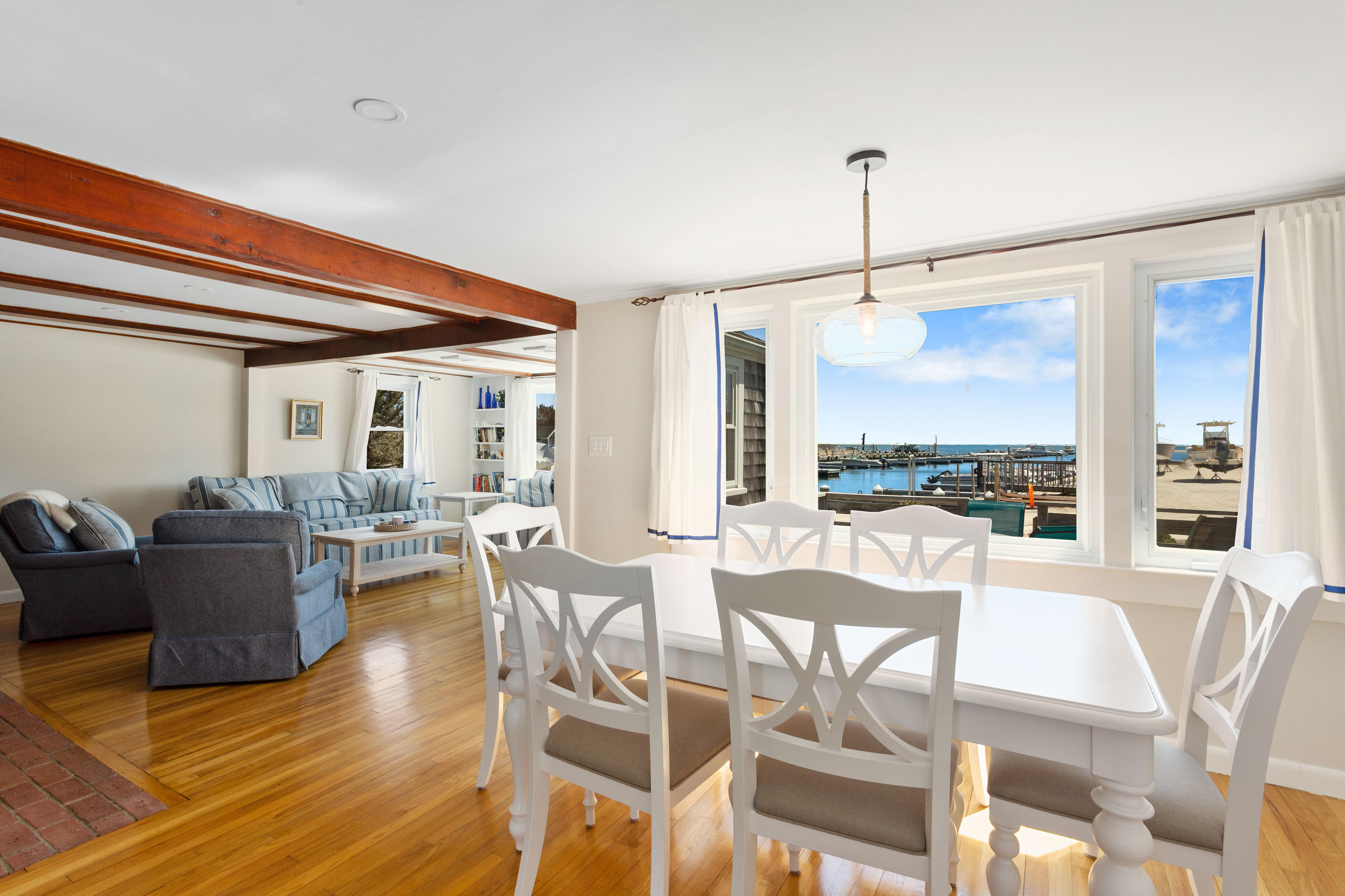 115 Seagull Road Chatham, MA 02633 - Photo 8 of 29 a view of a dining room with furniture window and wooden floor