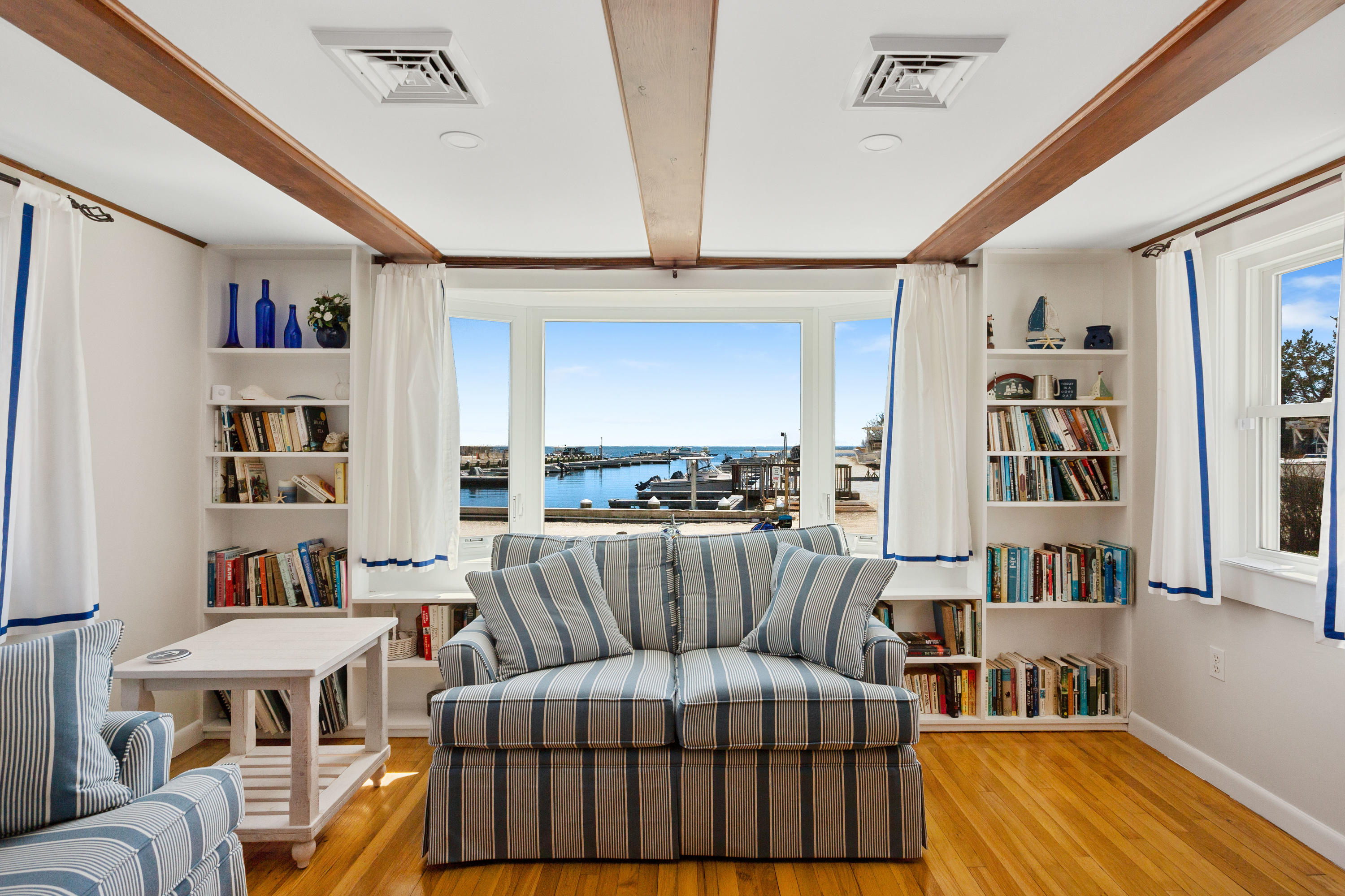 115 Seagull Road Chatham, MA 02633 - Photo 10 of 29 a living room with furniture a rug and a book shelf