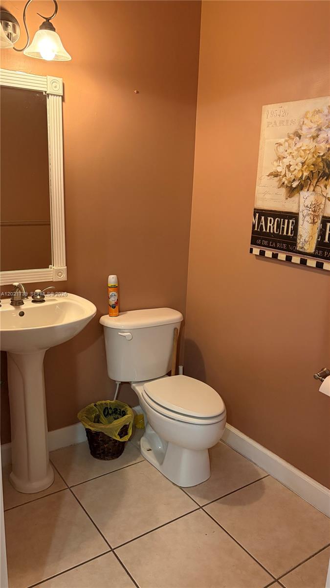 13553 Southwest 124th Avenue Road Miami, FL 33186 - Photo 15 of 31 a bathroom with a toilet sink and mirror