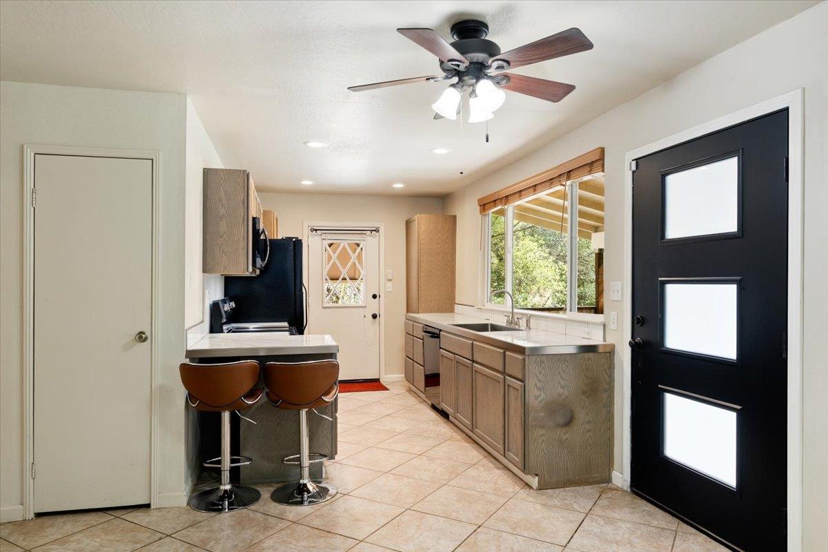 1302 Nicks Lane Placerville, CA 95667 - Photo 23 of 51 a kitchen with stainless steel appliances granite countertop a sink a stove and a refrigerator
