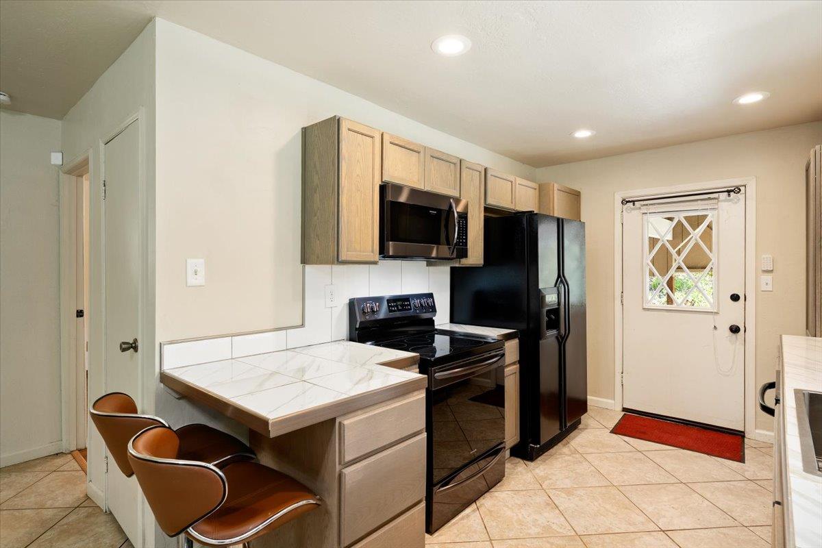 1302 Nicks Lane Placerville, CA 95667 - Photo 25 of 51 a kitchen with a refrigerator and a stove top oven
