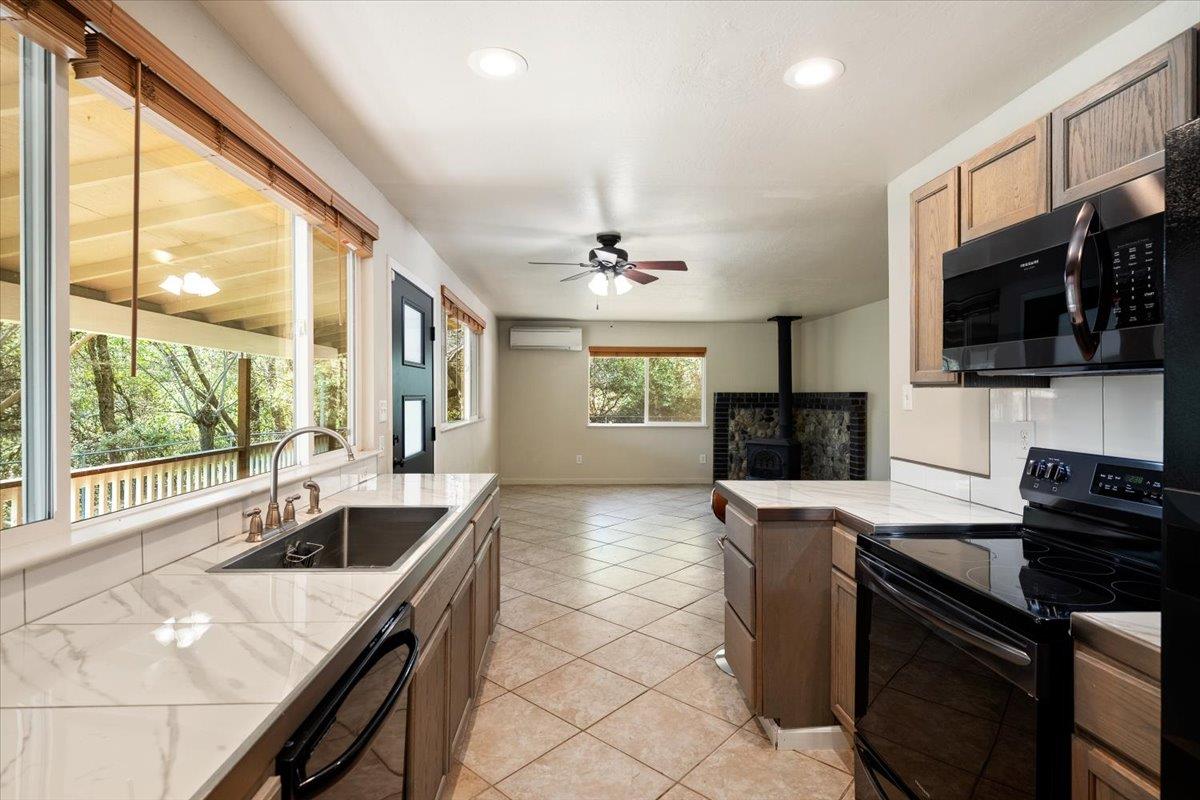 1302 Nicks Lane Placerville, CA 95667 - Photo 26 of 51 a kitchen with granite countertop a sink a counter top space appliances and cabinets