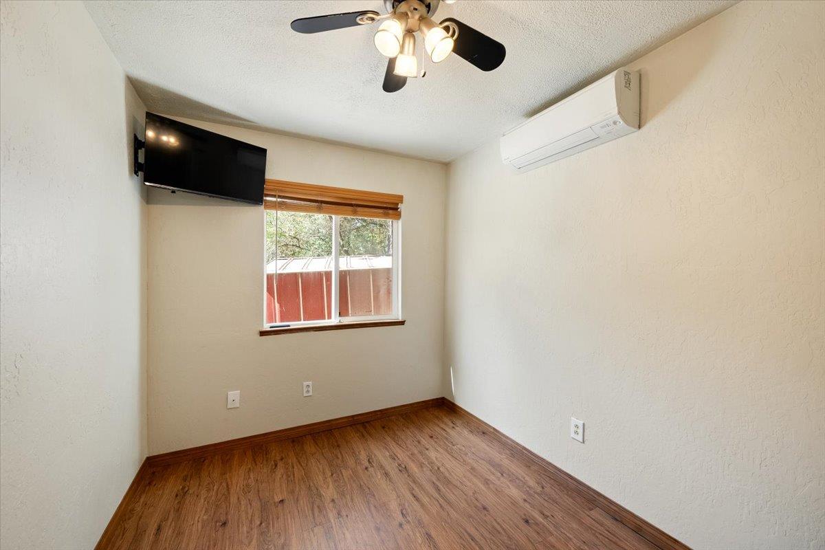 1302 Nicks Lane Placerville, CA 95667 - Photo 27 of 51 a view of an empty room with wooden floor and a window