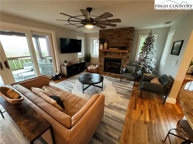 a living room with furniture and a floor to ceiling window