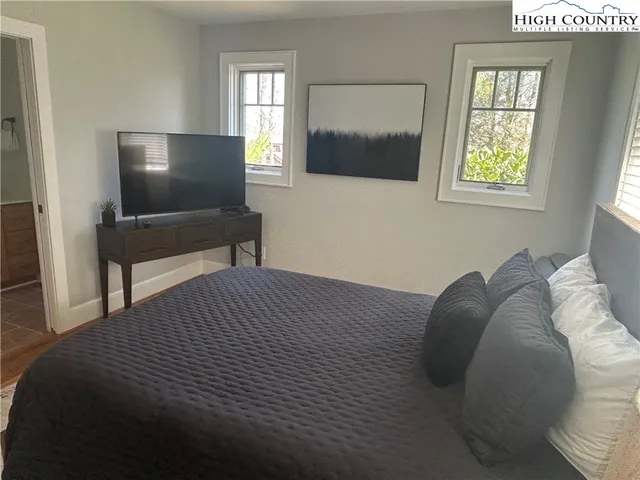 a large kitchen with a table chairs stove and refrigerator