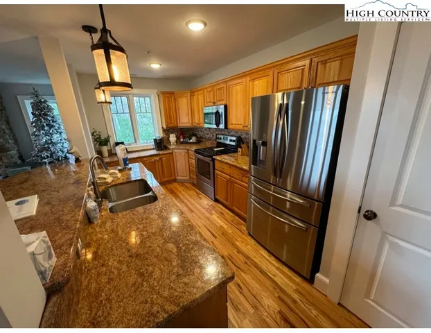 a kitchen with sink refrigerator and window