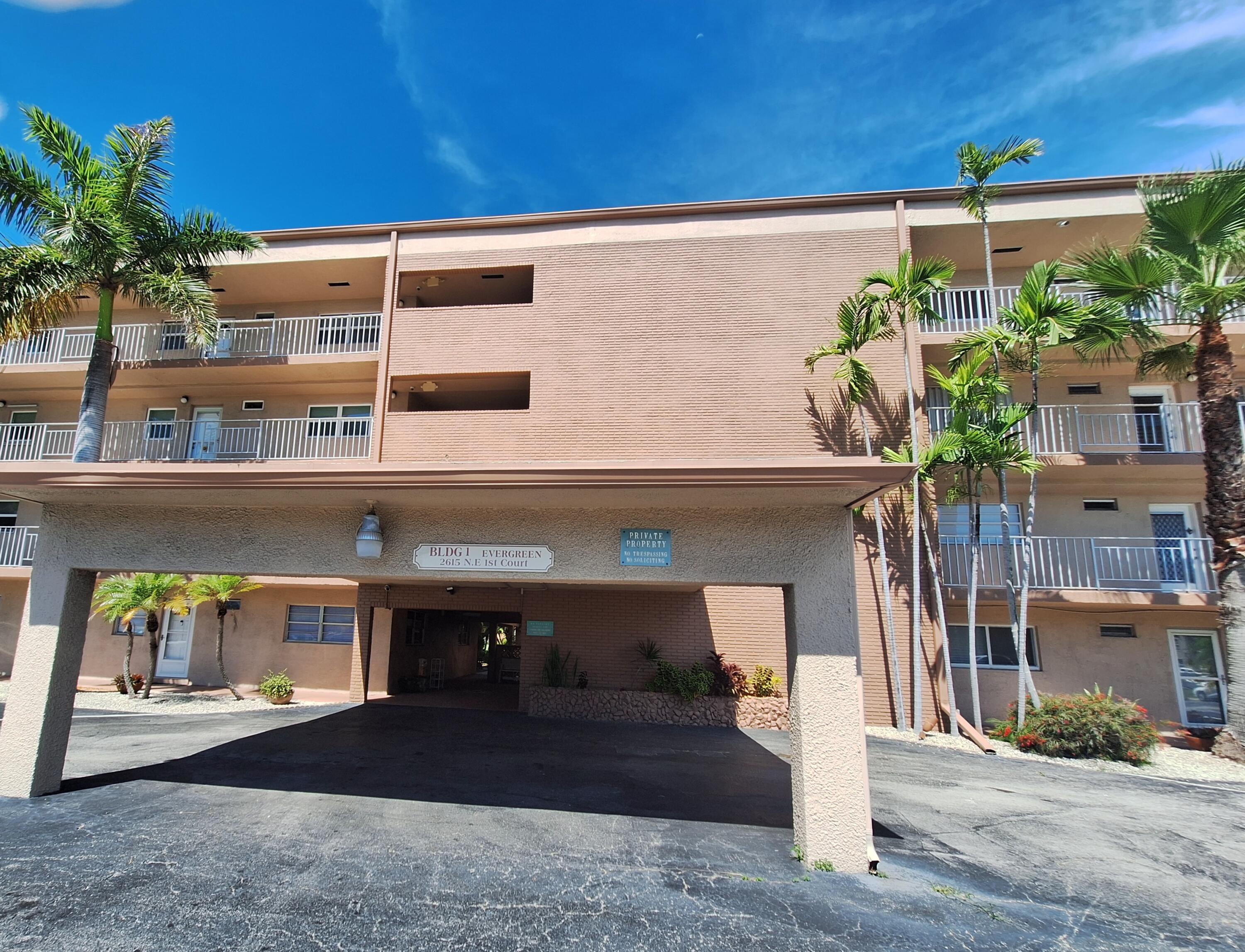 2615 Northeast 1st Court, Unit 307 Boynton Beach, FL 33435 - Photo 18 of 22 a front view of a building with entryway