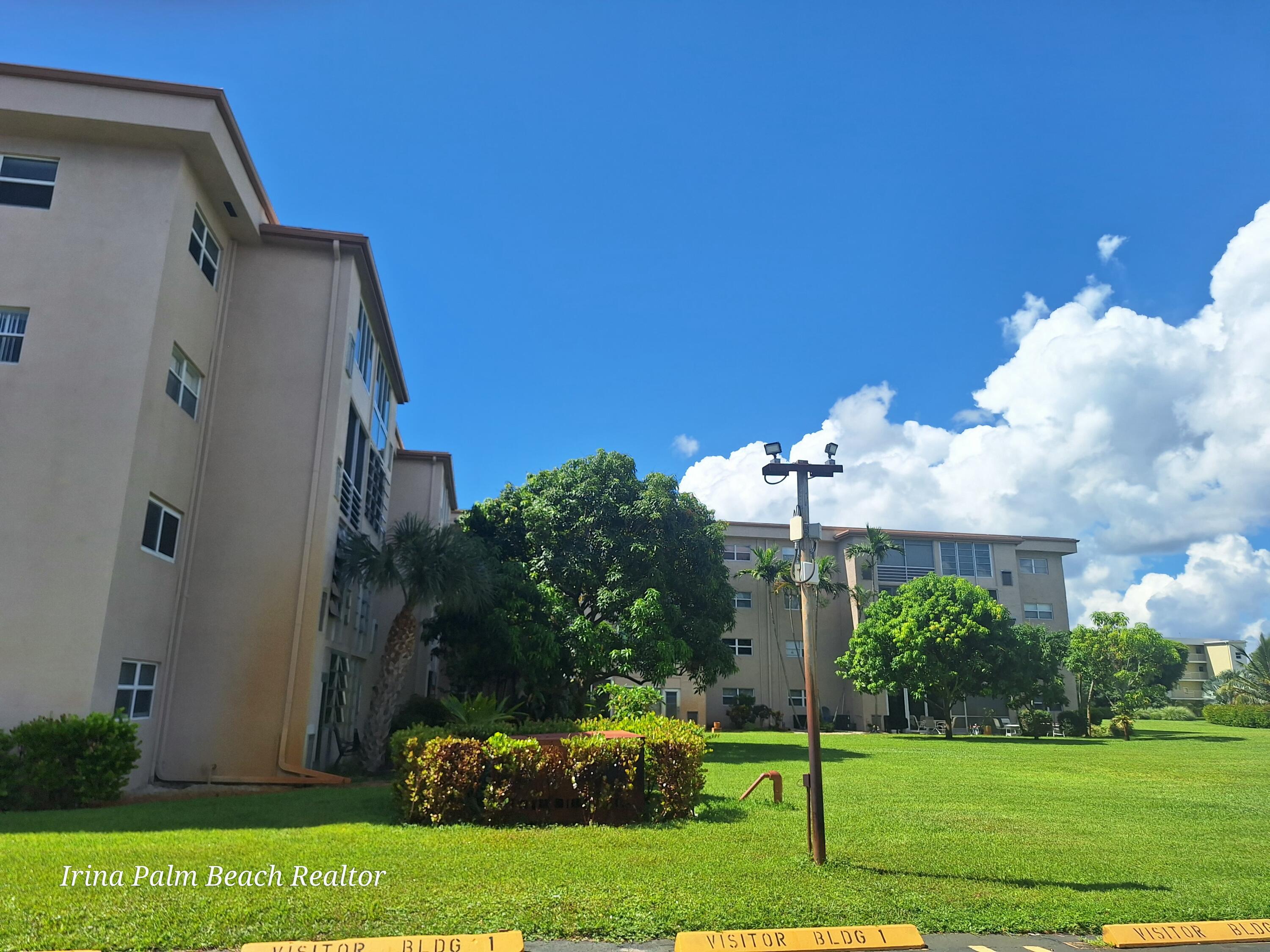 2615 Northeast 1st Court, Unit 307 Boynton Beach, FL 33435 - Photo 20 of 22 a front view of a house with a yard