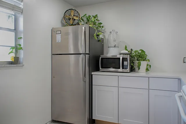 a white refrigerator freezer sitting inside of a kitchen