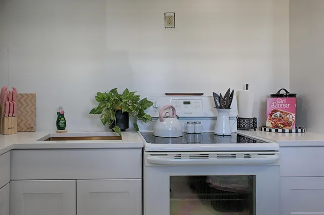 a kitchen with a stove and cabinets