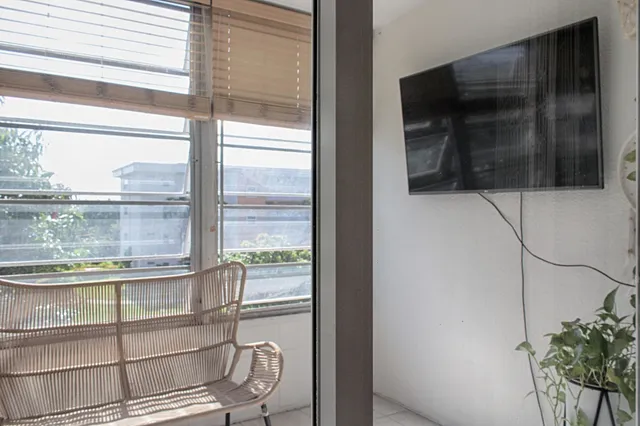a room with a large window and flat screen tv