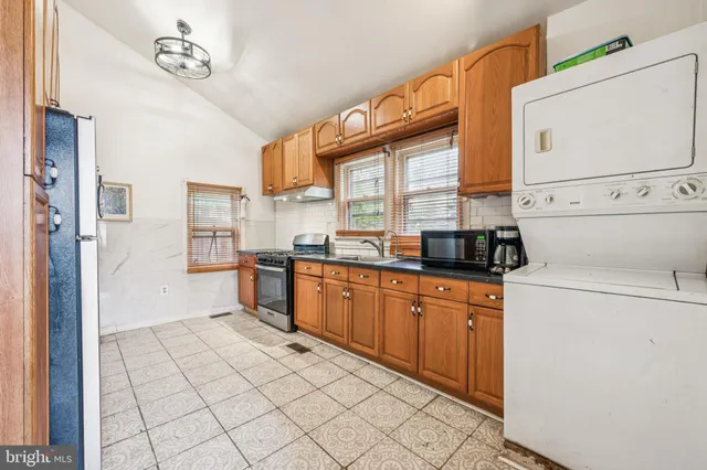 a kitchen with stainless steel appliances a refrigerator sink and cabinets