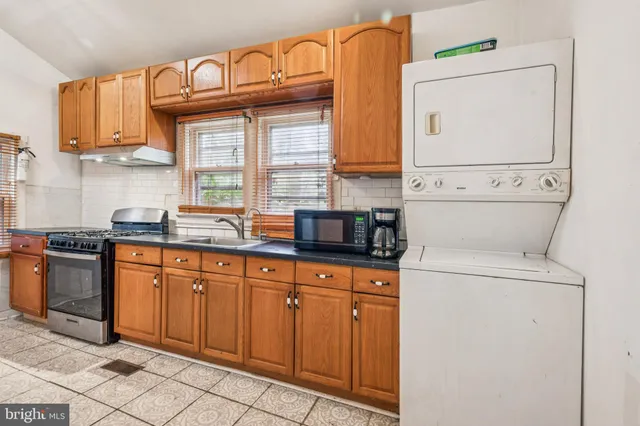 a kitchen with stainless steel appliances a sink and a refrigerator
