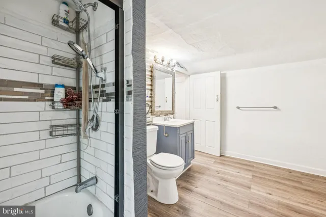 a bathroom with a toilet and a shower