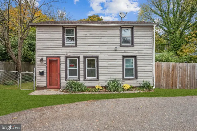 a front view of a house with a garden and plants