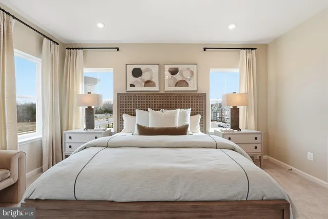 a bedroom with a large bed and a large window