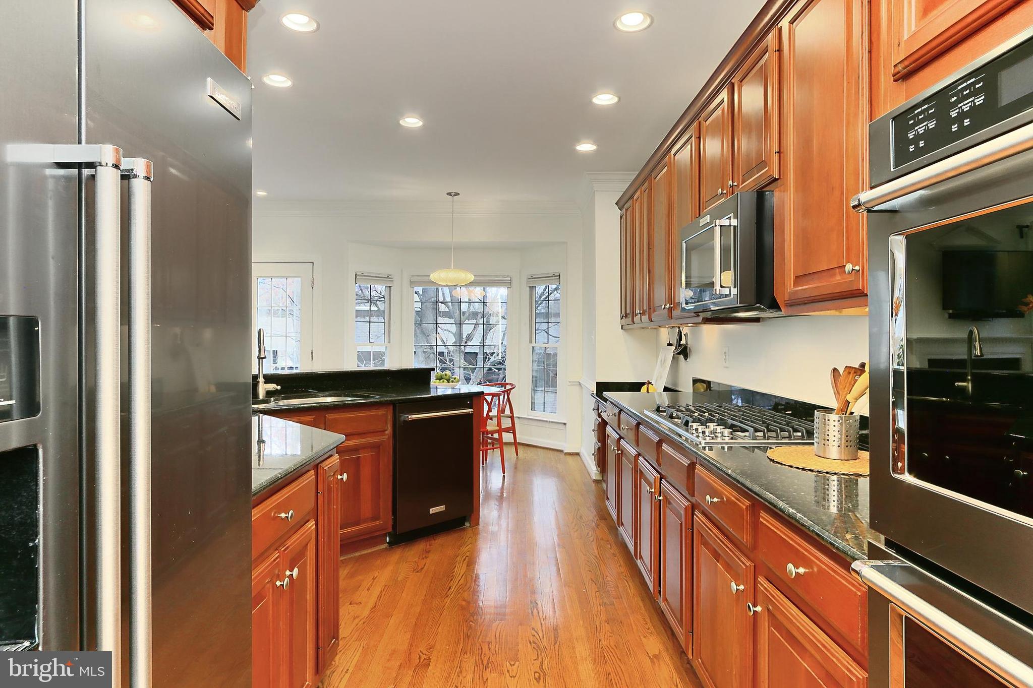 132 Rees Place Falls Church, VA 22046 - Photo 16 of 66 a kitchen with stainless steel appliances granite countertop a stove a sink and a refrigerator