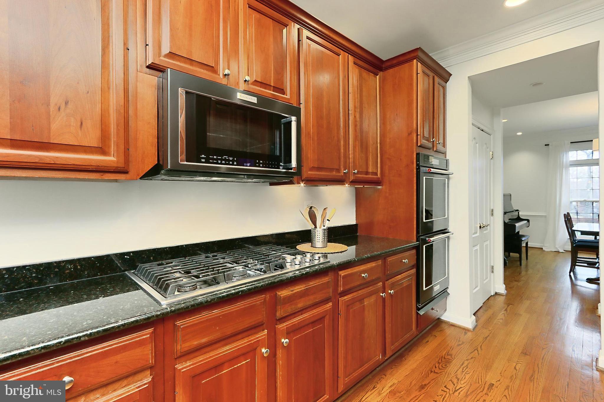 132 Rees Place Falls Church, VA 22046 - Photo 17 of 66 a kitchen with stainless steel appliances granite countertop a stove a sink and a microwave