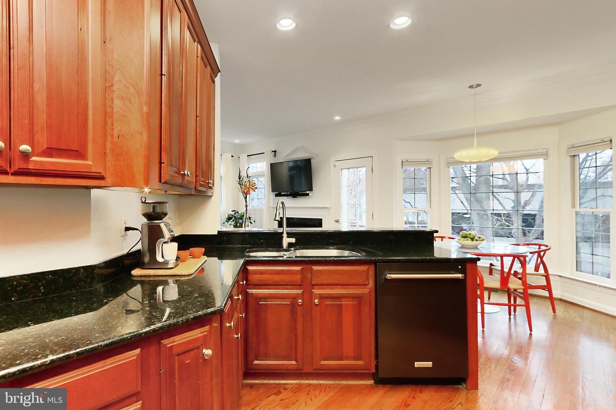 132 Rees Place Falls Church, VA 22046 - Photo 20 of 66 a kitchen with granite countertop a stove a sink dishwasher and cabinets with wooden floor