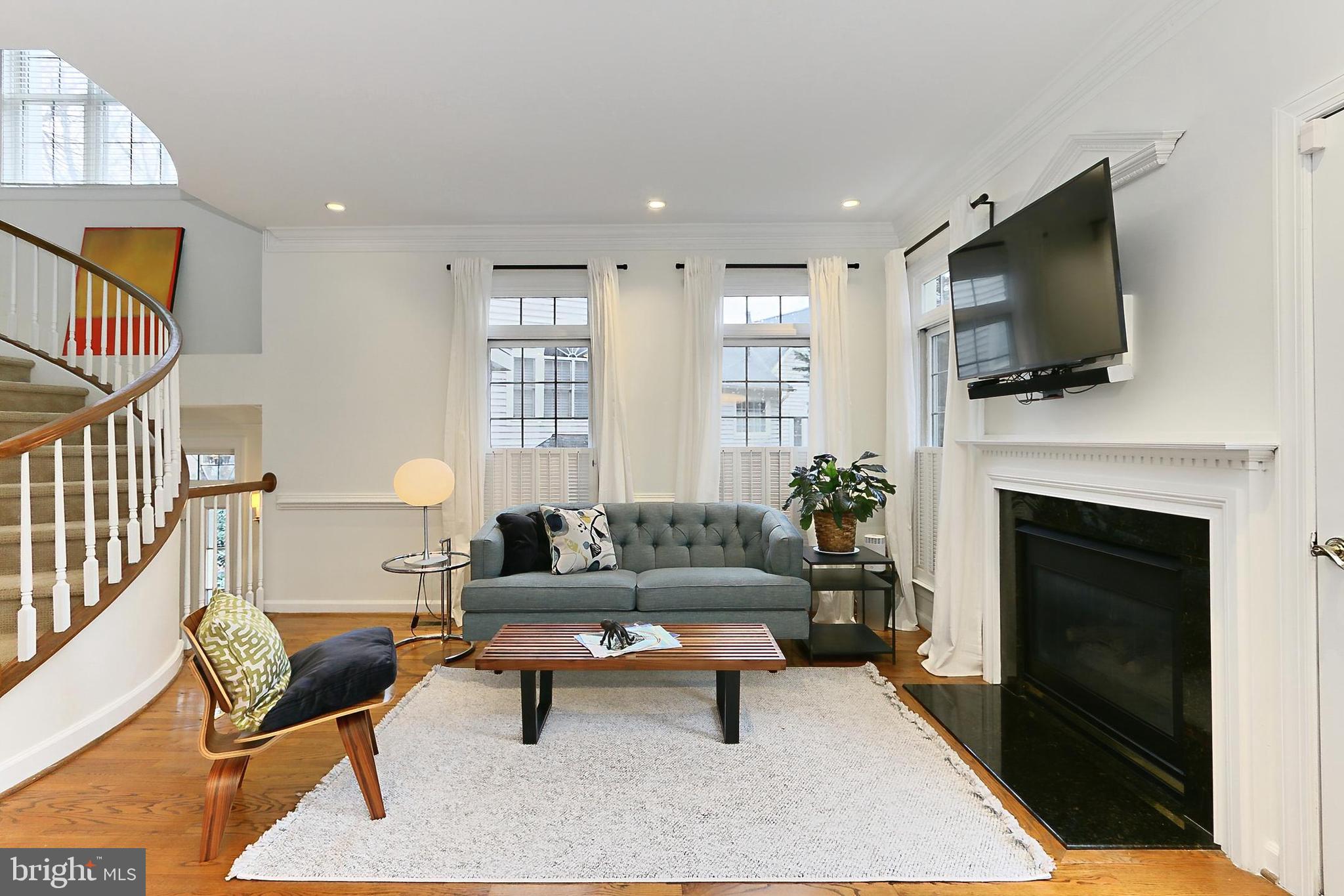 132 Rees Place Falls Church, VA 22046 - Photo 24 of 66 a living room with furniture a flat screen tv and a fireplace