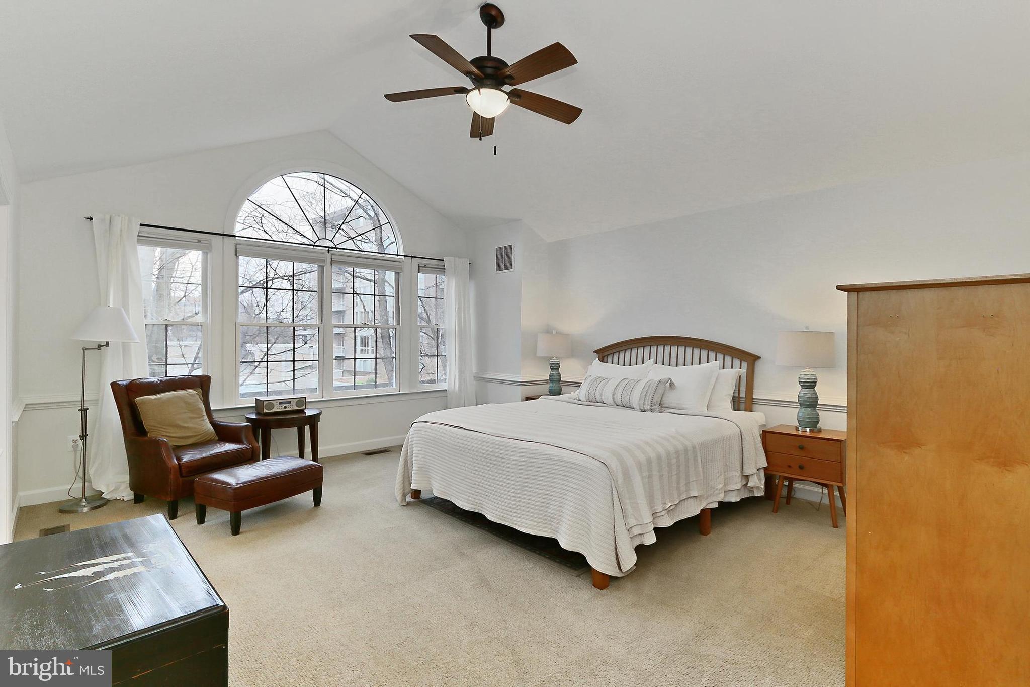132 Rees Place Falls Church, VA 22046 - Photo 32 of 66 a spacious bedroom with a bed a chandelier and a large window