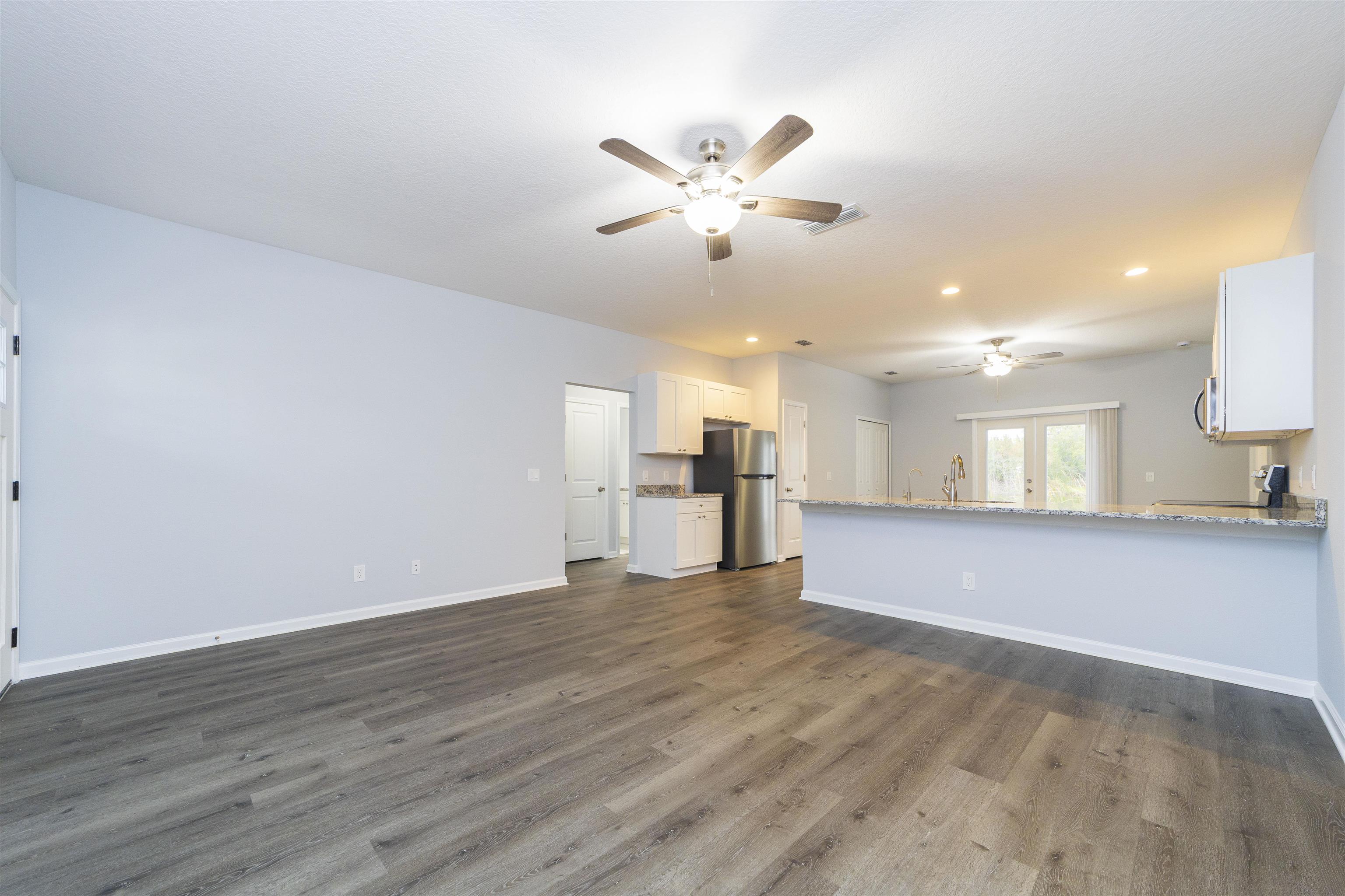 679 Coral Circle St. Augustine, FL 32080 - Photo 14 of 48 a view of an empty room with window and wooden floor