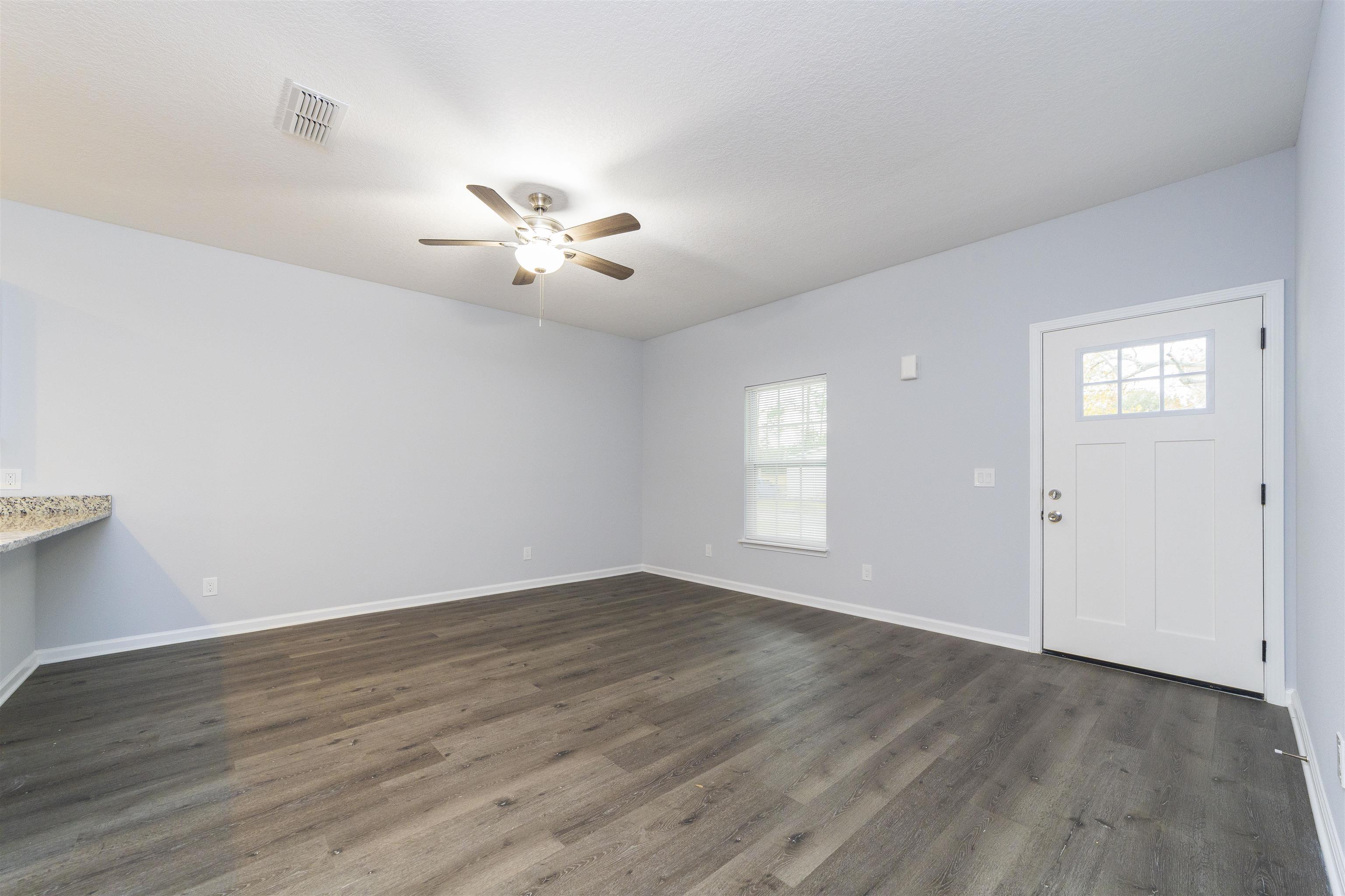 679 Coral Circle St. Augustine, FL 32080 - Photo 16 of 48 a view of an empty room with a window and wooden floor