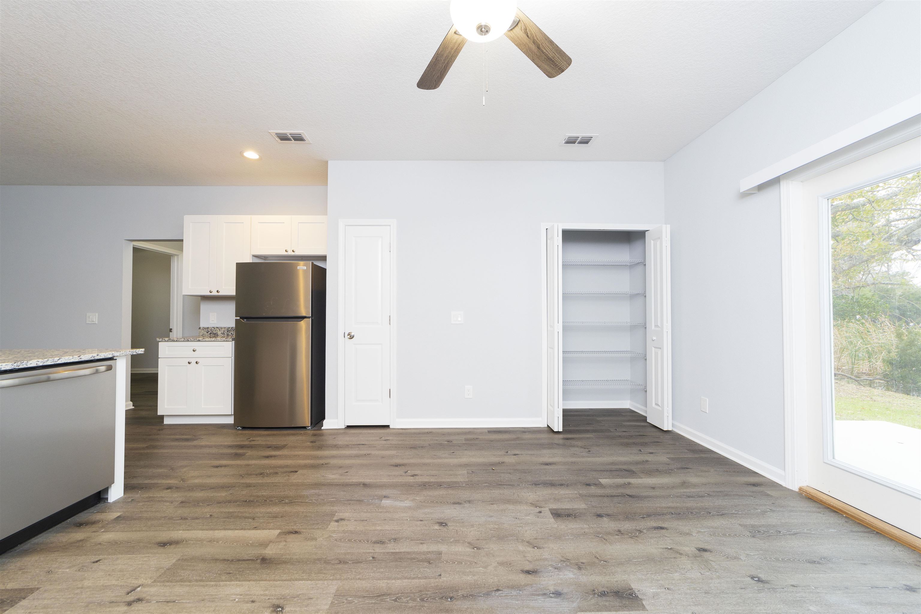 679 Coral Circle St. Augustine, FL 32080 - Photo 18 of 48 a view of a room with a refrigerator and a window