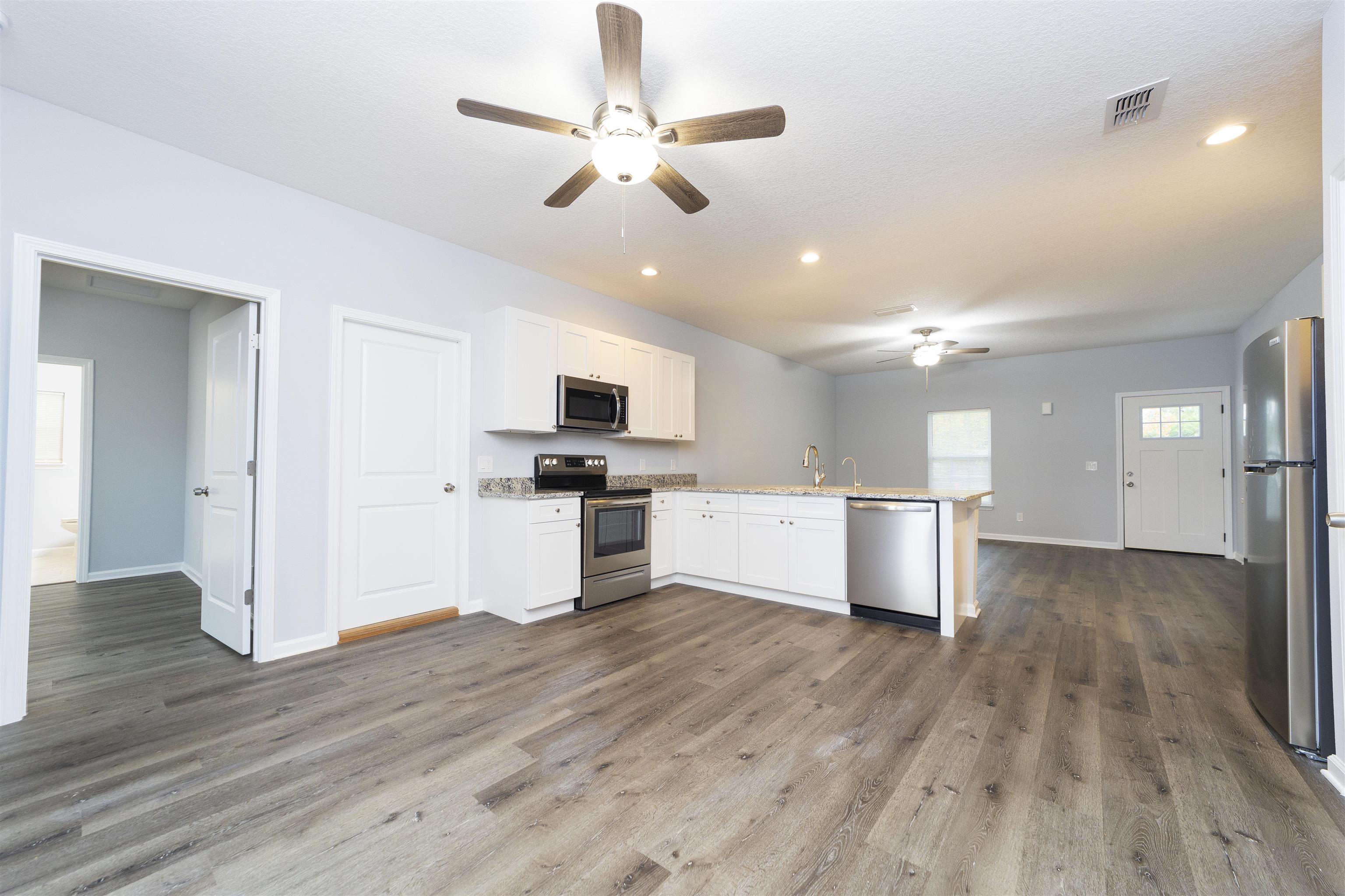 679 Coral Circle St. Augustine, FL 32080 - Photo 20 of 48 a view of kitchen with microwave and refrigerator