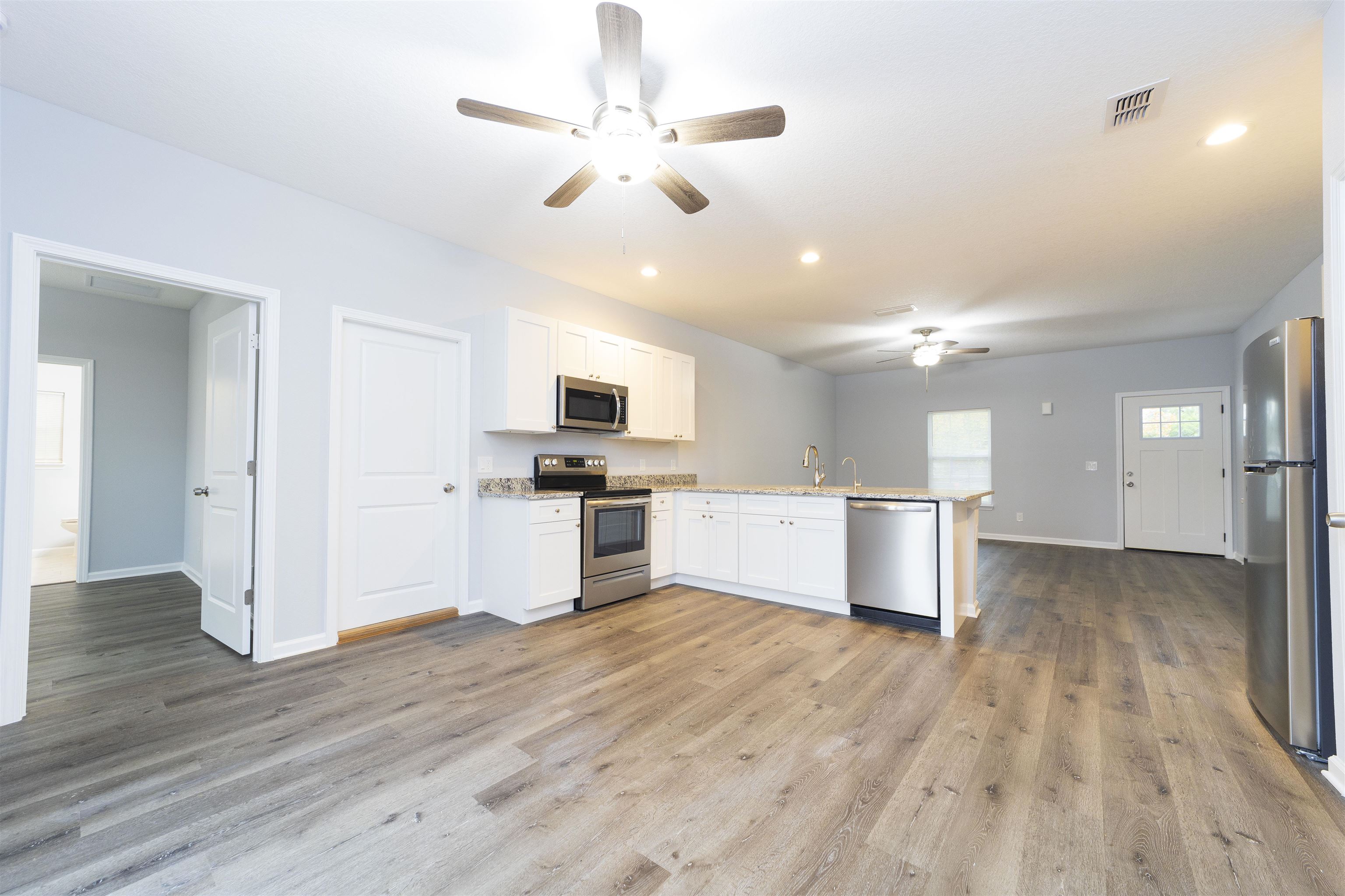 679 Coral Circle St. Augustine, FL 32080 - Photo 21 of 48 a view of kitchen with granite countertop cabinets and refrigerator