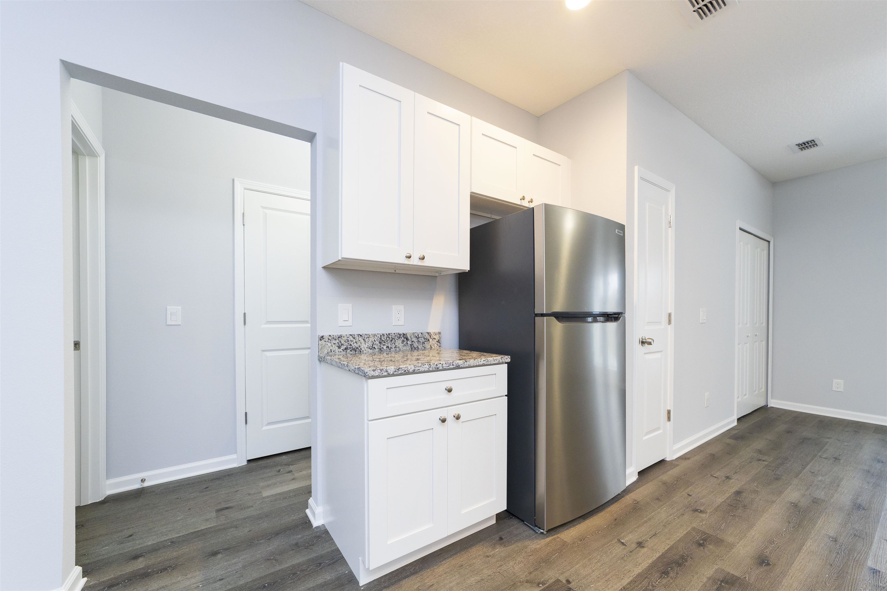 679 Coral Circle St. Augustine, FL 32080 - Photo 23 of 48 a kitchen with a refrigerator sink and cabinets
