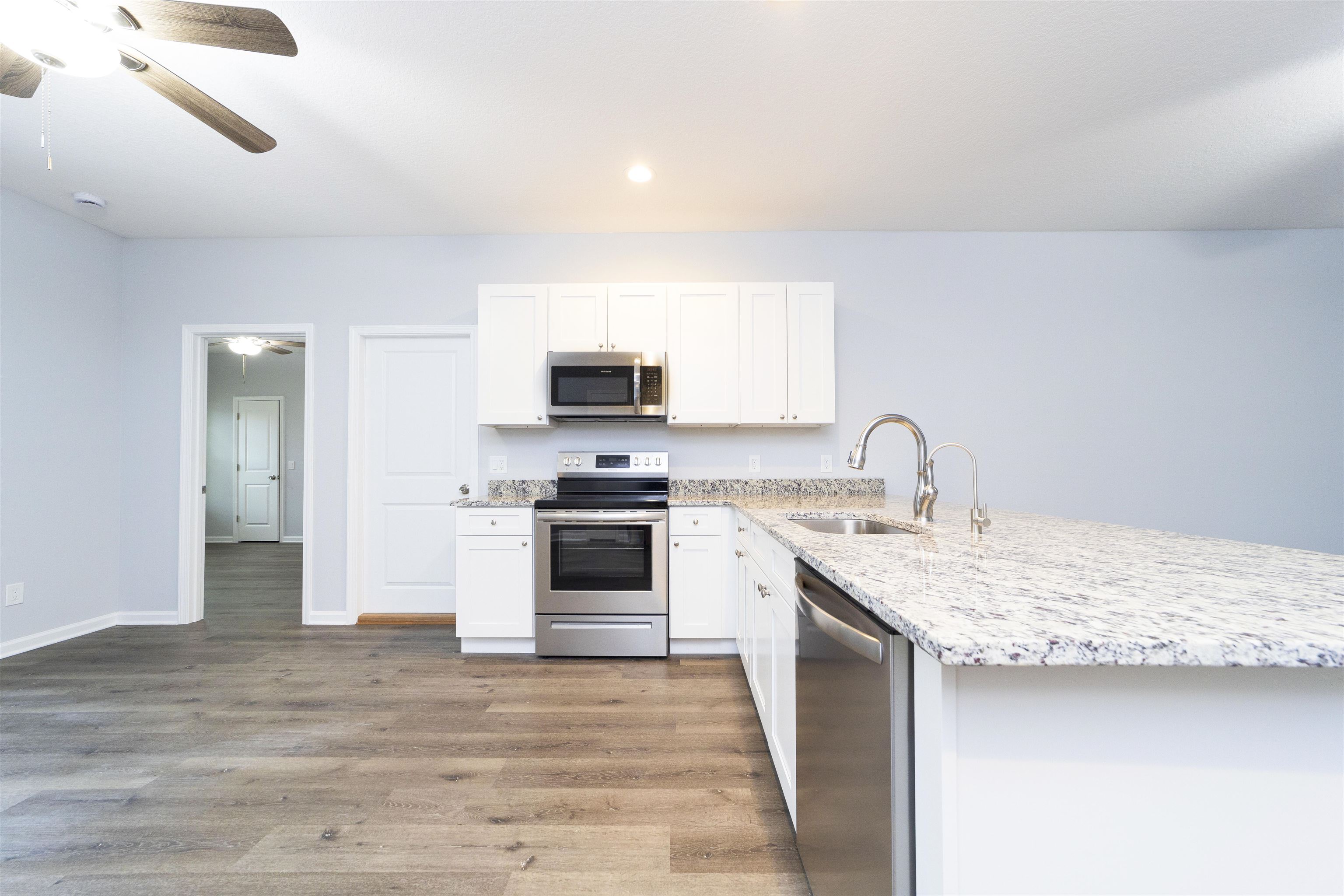 679 Coral Circle St. Augustine, FL 32080 - Photo 24 of 48 a kitchen with stainless steel appliances kitchen island a sink stove and refrigerator