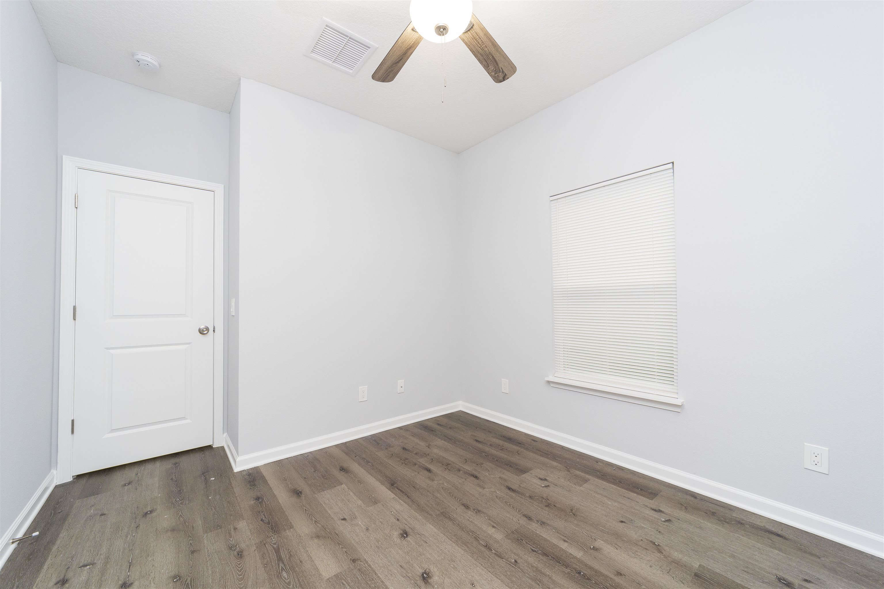 679 Coral Circle St. Augustine, FL 32080 - Photo 27 of 48 an empty room with wooden floor and windows