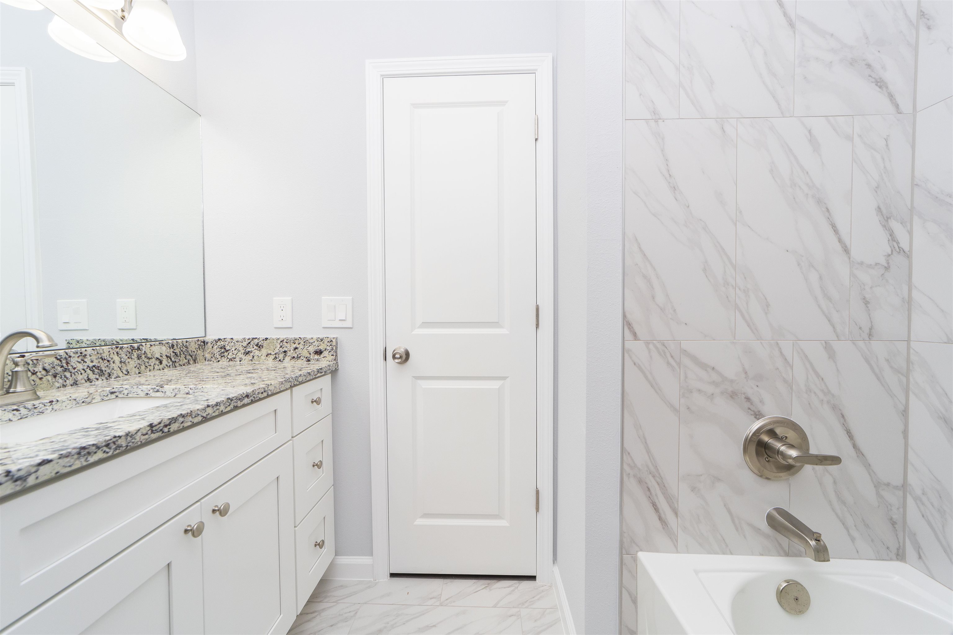 679 Coral Circle St. Augustine, FL 32080 - Photo 31 of 48 a bathroom with a granite countertop sink and vanity