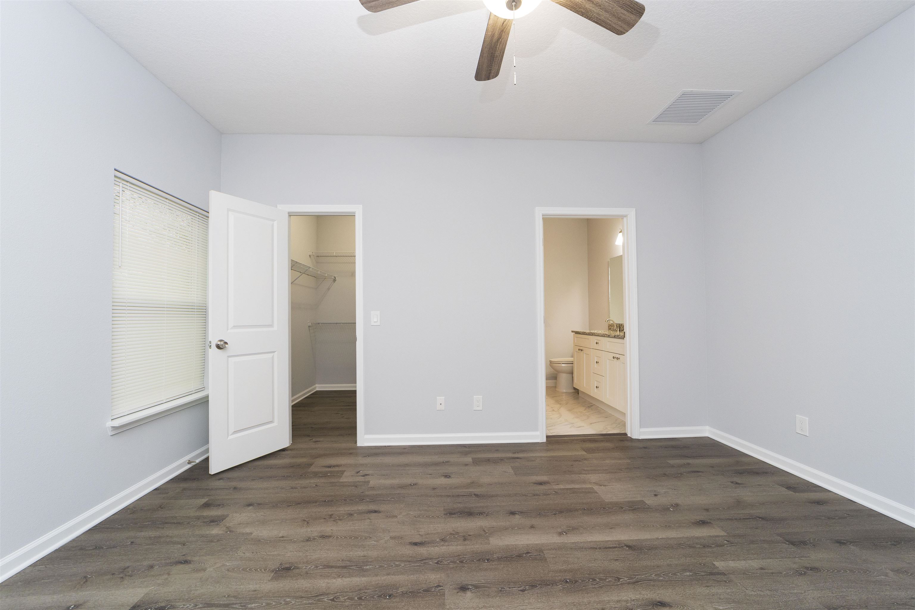 679 Coral Circle St. Augustine, FL 32080 - Photo 39 of 48 an empty room with wooden floor chandelier fan and windows