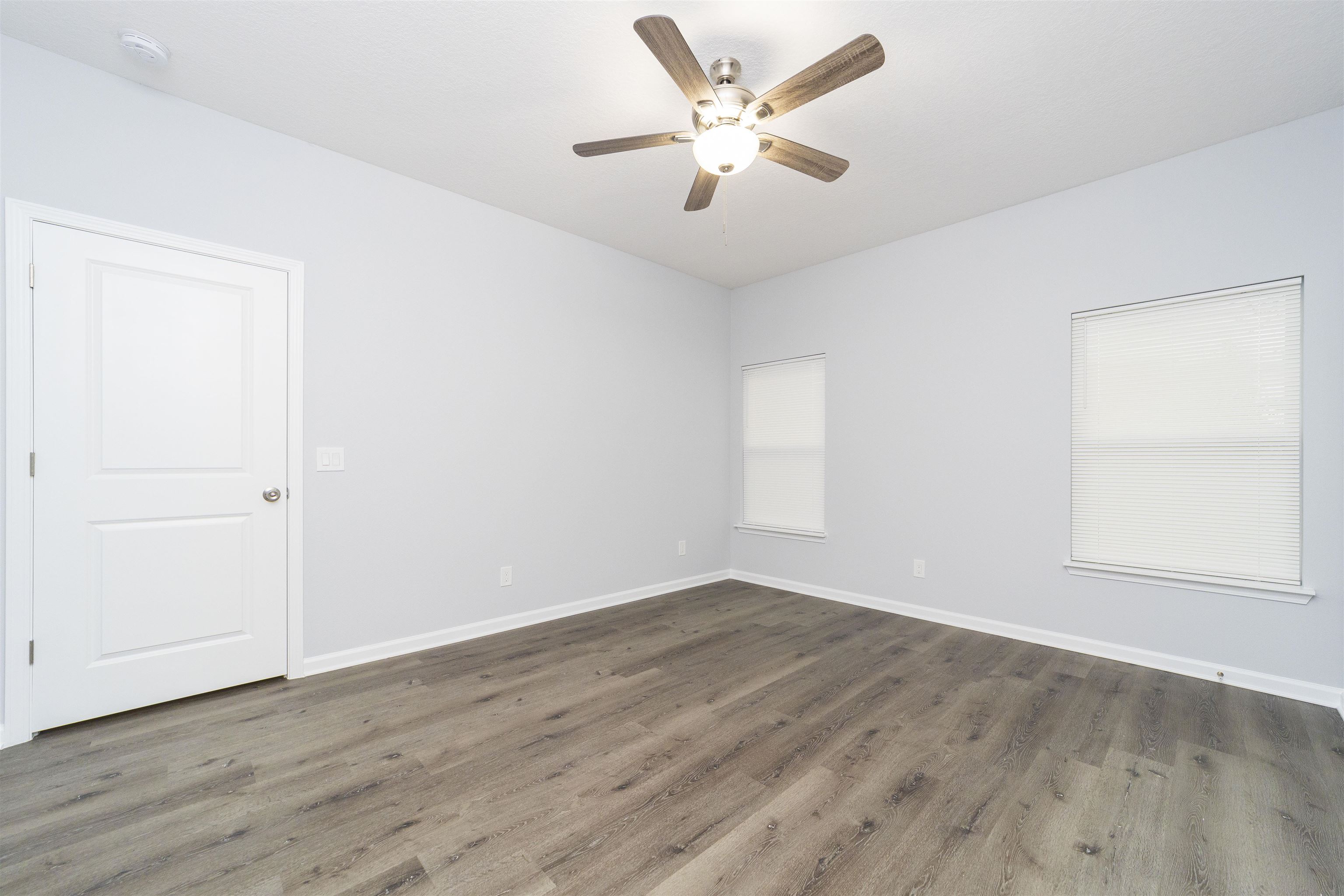 679 Coral Circle St. Augustine, FL 32080 - Photo 46 of 48 an empty room with wooden floor and windows