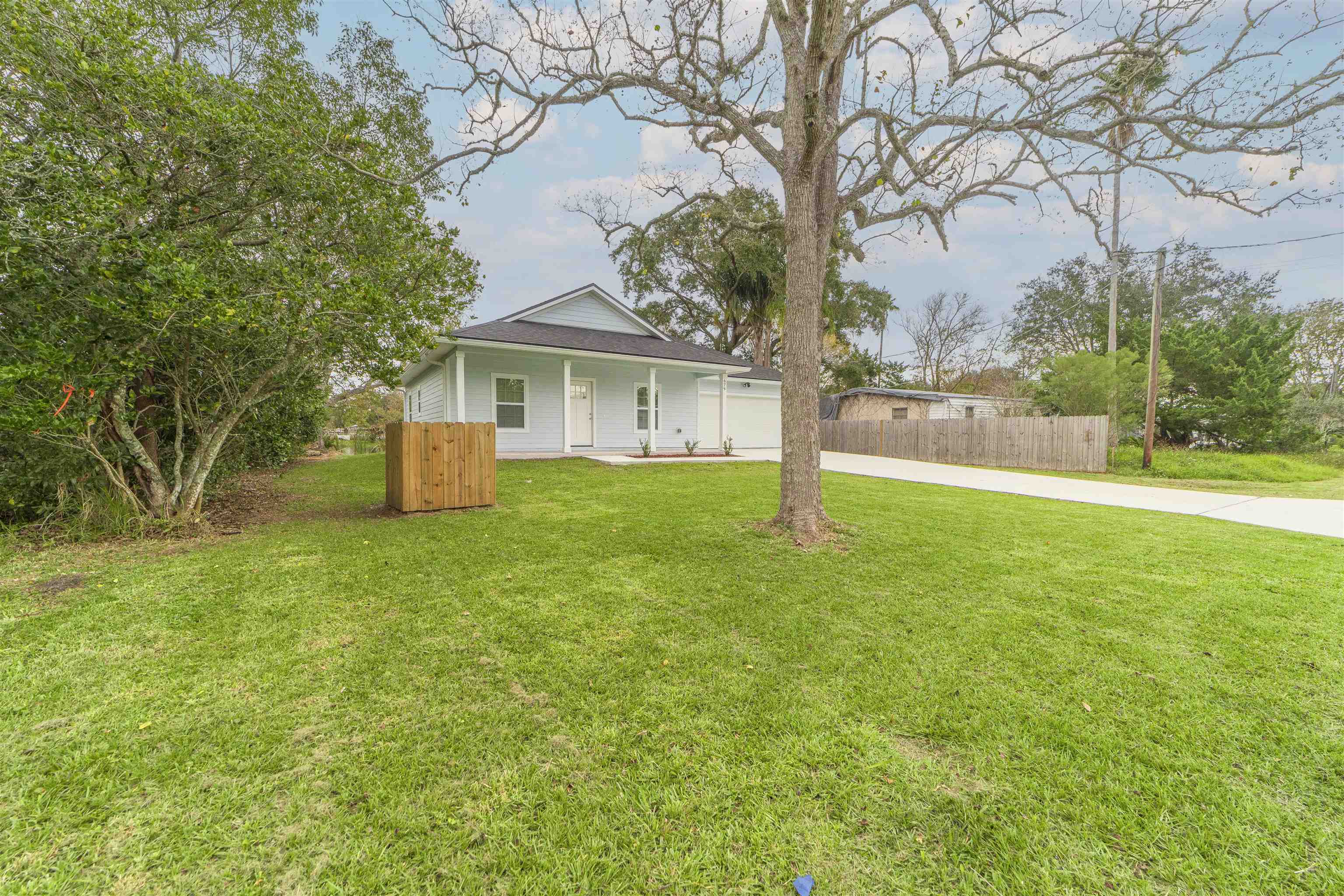 679 Coral Circle St. Augustine, FL 32080 - Photo 5 of 48 a view of a house with a yard and large trees