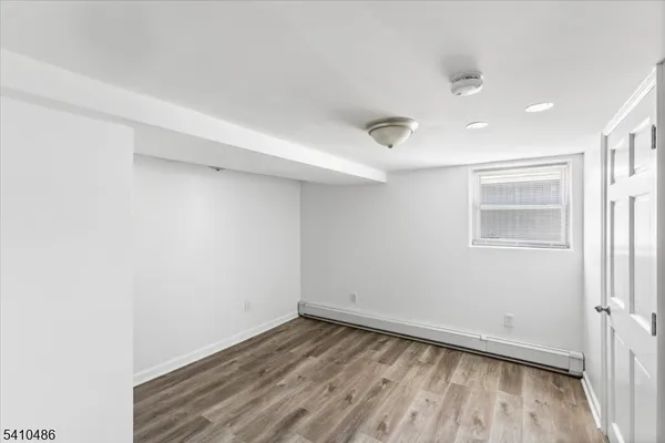 a view of a room with wooden floor and window
