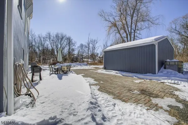 a view of a backyard with a snow on the road
