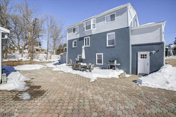 a view of a house with snow on the road