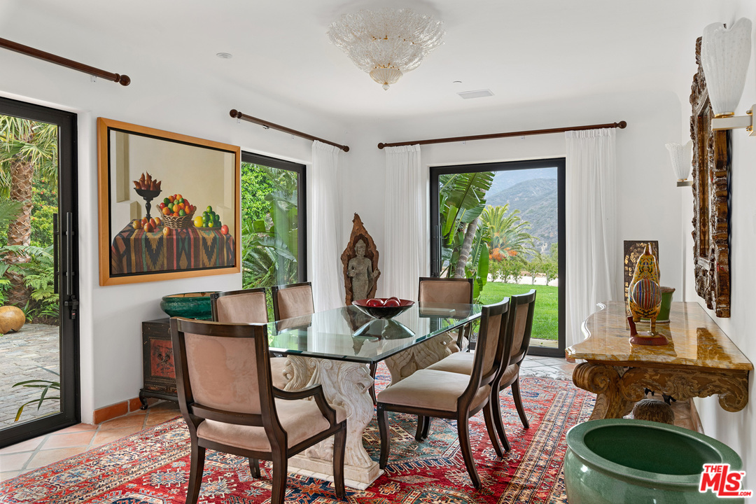 21424 Deerpath Lane Malibu, CA 90265 - Photo 14 of 51 a dining room with furniture a window and a chandelier