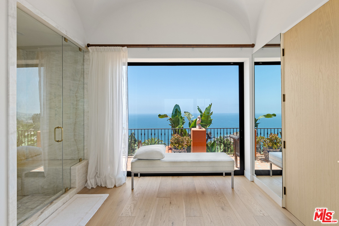 21424 Deerpath Lane Malibu, CA 90265 - Photo 30 of 51 a bedroom with a bed and a potted plant