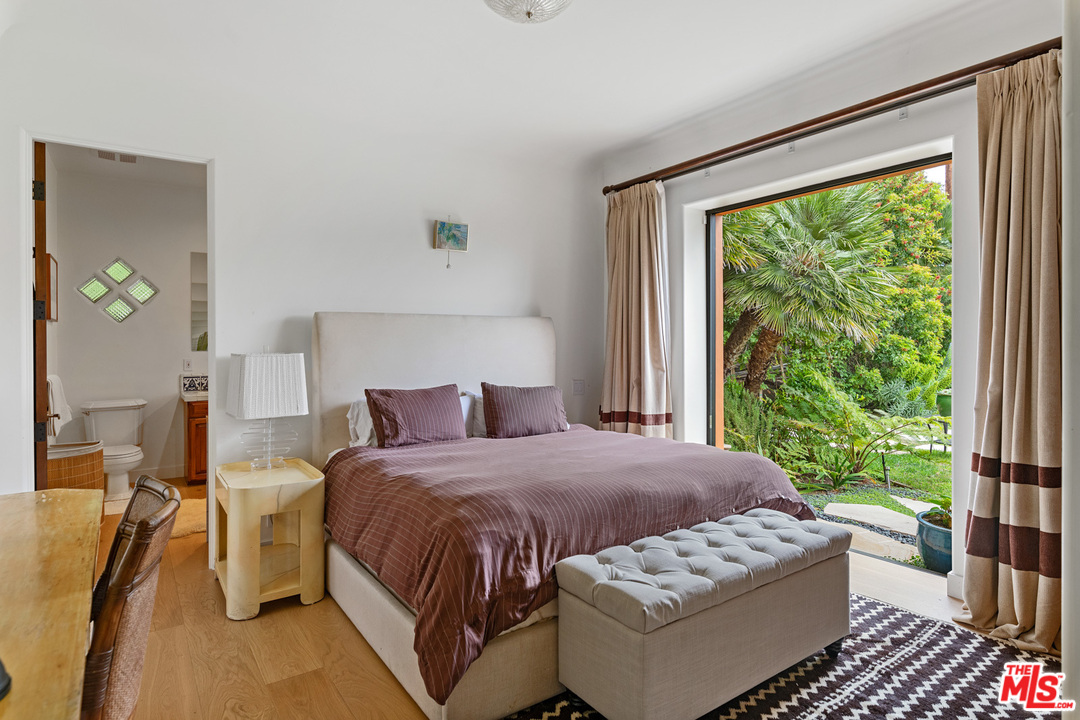 21424 Deerpath Lane Malibu, CA 90265 - Photo 32 of 51 a bedroom with a bed and wooden floor