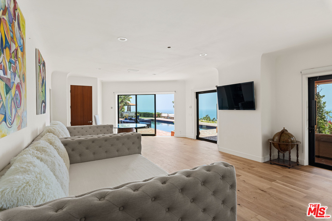 21424 Deerpath Lane Malibu, CA 90265 - Photo 37 of 51 a living room with furniture and a flat screen tv