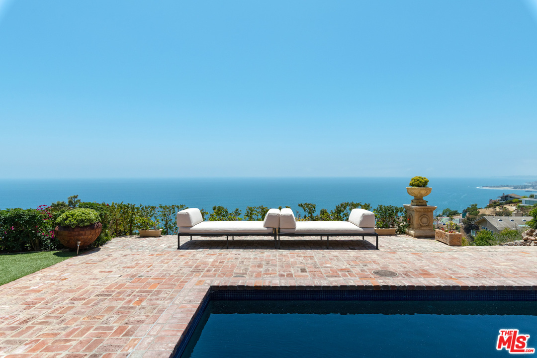 21424 Deerpath Lane Malibu, CA 90265 - Photo 42 of 51 a bedroom with a bed and a potted plant